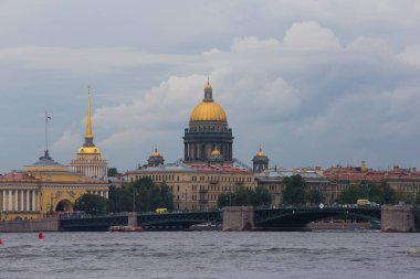 SAINT PETERSBURG, RUSSIA 12.08.2021 city panorama from Neva river embankment by Peter and Paul Fortress on a grey cloudy day. Trinity Bridge, Saint Isaac's Cathedral, Admiralty in the background