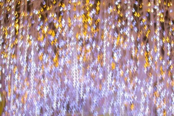 Yeni yılı kutlamak için Noel ışıkları tarafından oluşturulan bulanık bokeh arka plan. Güzel Noel ışıkları arka planı ve arka planı her tasarım ya da Noel tebrik kartı için kullanılabilir..