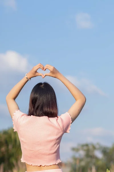 Woman Lifts Both Her Hands Her Head Make Heart Symbol — Stockfoto