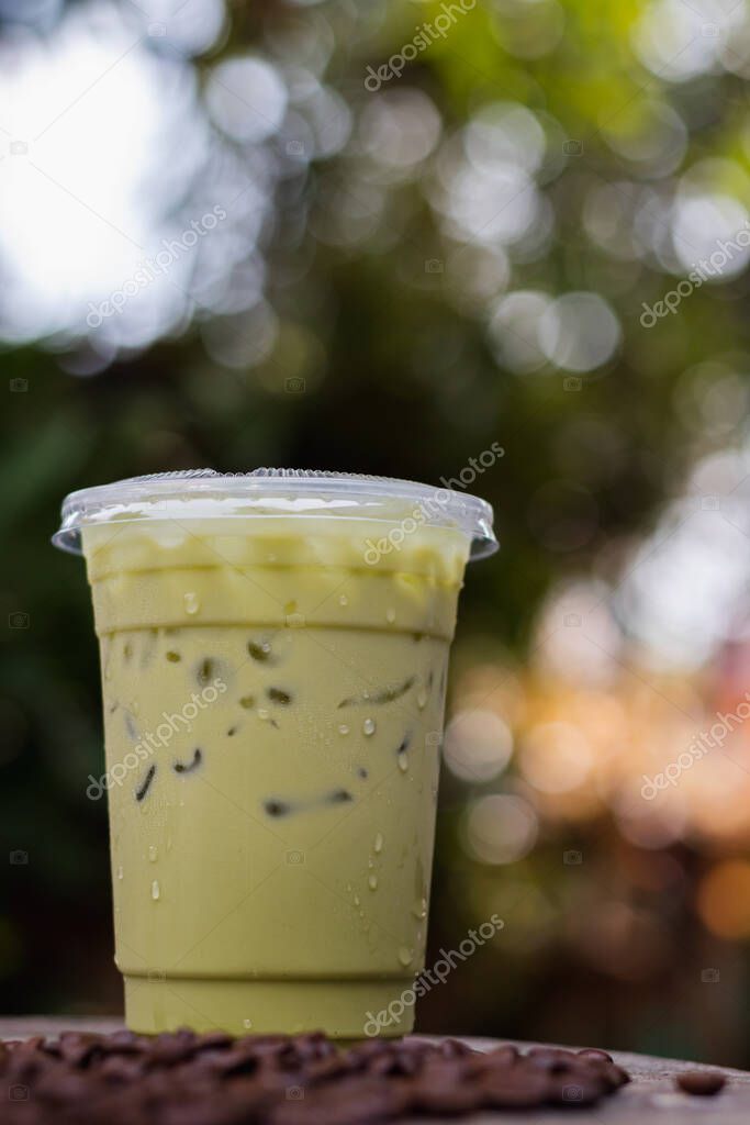 Iced green tea caffeine containing beverage is placed on counter at