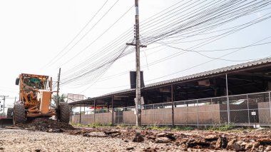Chiang Mai Thai 23 December 2021 Construction workers are adjusting road surface with heavy machinery to achieve smooth surface and compact ground before pouring reinforced concrete give road strength