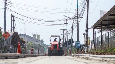Chiang Mai Thai 23 December 2021 Construction workers are adjusting road surface with heavy machinery to achieve smooth surface and compact ground before pouring reinforced concrete give road strength