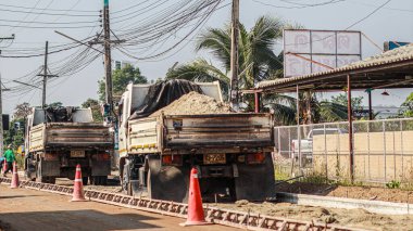 Chiang Mai Thai 23 December 2021 Construction workers are adjusting road surface with heavy machinery to achieve smooth surface and compact ground before pouring reinforced concrete give road strength