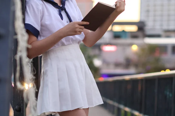 Young Girl Wearing White School Uniform Stands Balcony Reading Book — Foto de Stock