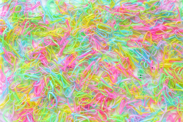 The colorful hair rubber band backgrounds are laid out on a lot of ground, making them an ideal background for designs and copy space for advertising text. colorful fashion hair rubber band background