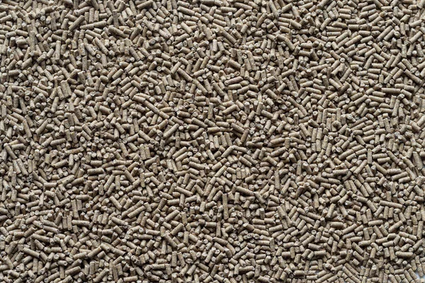 Animal feed mixed from finely ground protein powders of both plants and animals is pelleted to be used as pet food because pellets are convenient and accurate in feeding quantity.Copy Space background;