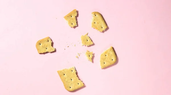 Broken Cracker Small Pieces Pink Background Top View — Stock Photo, Image