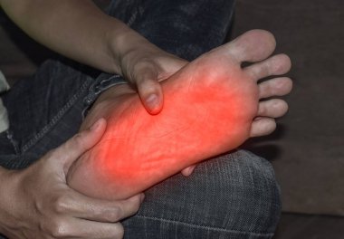 Tingling and burning sensation in foot of Asian young man with diabetes. Foot pain. Sensory neuropathy problems. Foot nerves problems. Plantar fasciitis. clipart