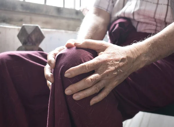 Knee joint pain in Asian Myanmar elder man. Concept of osteoarthritis, rheumatoid arthritis, patellar tendonitis, prepatellar bursitis, collateral ligament injury or baker cyst.