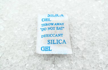Sachet of new silica gel crystals. It is a desiccant. It adsorbs and holds water vapor.