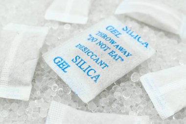 Sachet of new silica gel crystals. It is a desiccant. It adsorbs and holds water vapor.