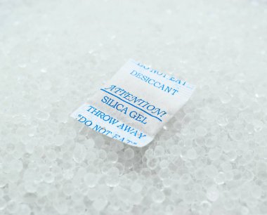 Sachet of new silica gel crystals. It is a desiccant. It adsorbs and holds water vapor.