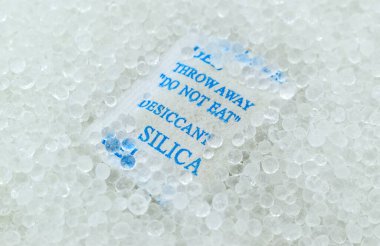 Sachet of new silica gel crystals. It is a desiccant. It adsorbs and holds water vapor.