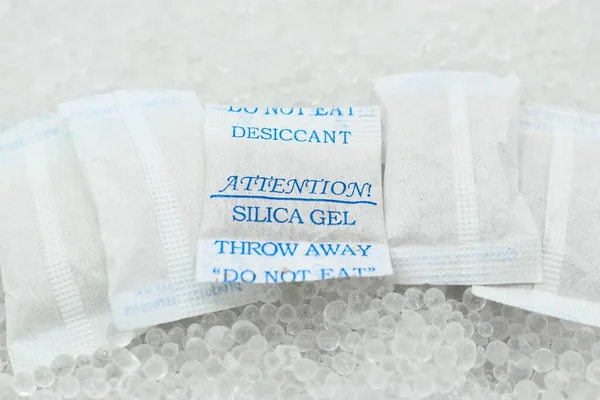 Sachet of new silica gel crystals. It is a desiccant. It adsorbs and holds water vapor.