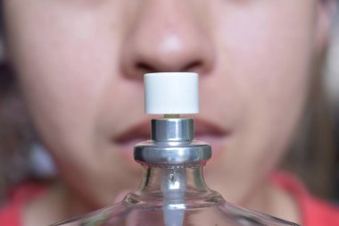 Southeast Asian, Chinese and Myanmar young man with cold flu gets loss of smell called anosmia. He smells scent of perfume.