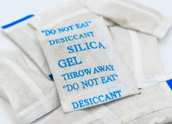 Sachets of new silica gel crystals. It is a desiccant. It adsorbs and holds water vapor.