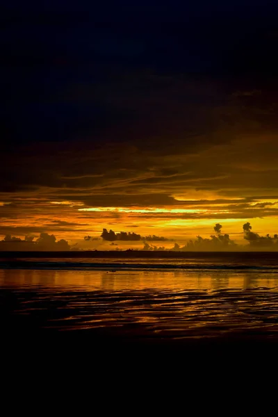 Magic scene of sunset at Chaung Tha beach. Cloudy sky. Golden hour at seaside.