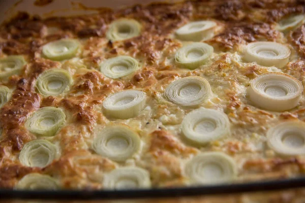 Close up of a Leek pie, with chunks of leek on top