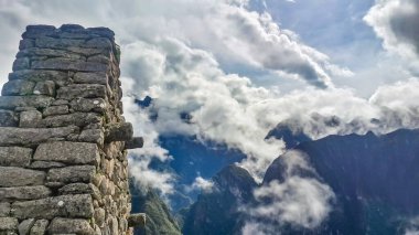 Stone Temple in Machu Picchu on foggy day early in the morning. High angle view. Natural and historical background with copy space. Machu Picchu is an Incan citadel set high in Andes Mountains in Peru