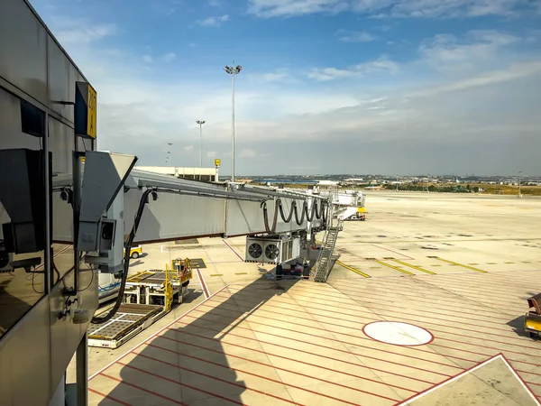 Extension of boarding bridge. No brand. Aviation crisis. Empty airfield. Airport tarmac, no people. Travel Background with copy space