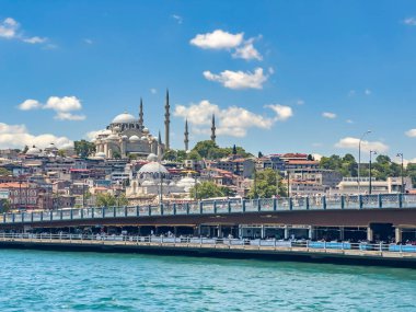 Galata bridge, Yeni Cami (New Mosque) and Suleymaniye Mosque in a row. The entrance of the Golden Horn in Istanbul Turkey, on a sunny day. Beautiful travel destination postcard, poster banner