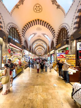 Istanbul, Turkey, 07.14.2022: Egyptian Bazaar (Misir Carsisi) or Spice Market at opening hours. Shopping tourists historical Grand Bazaar. Arcades with spices, nuts and sweets. Old ceiling decoration.