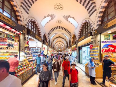 Istanbul, Turkey, 07.14.2022: Egyptian Bazaar (Misir Carsisi) or Spice Market at opening hours. Shopping tourists historical Grand Bazaar. Arcades with spices, nuts and sweets. Old ceiling decoration.