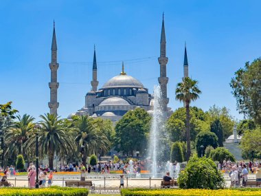 Istanbul, Turkey - July 14, 2022: Gorgeous Sultan Ahmed Mosque, known as the famous Blue Mosque in Istanbul. Fountain view. Tourist walking at the Sultanahmet Park on beautiful sunny day. 