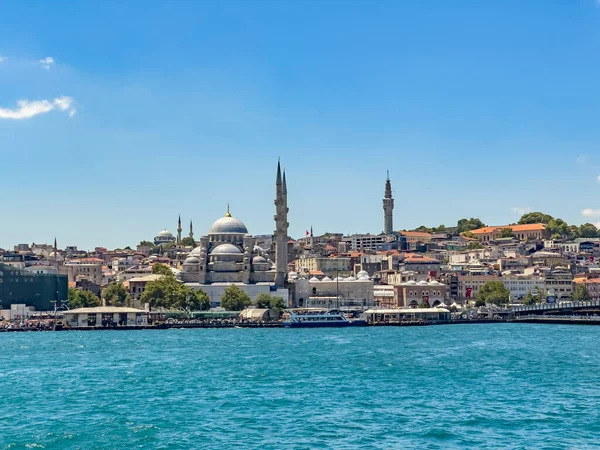 Eminonu - Sirkeci district of Istanbul on a sunny day with Yeni Cami (New Mosque) and the Istanbul University meteorology tower in background. Beautiful travel destination postcard, poster banner