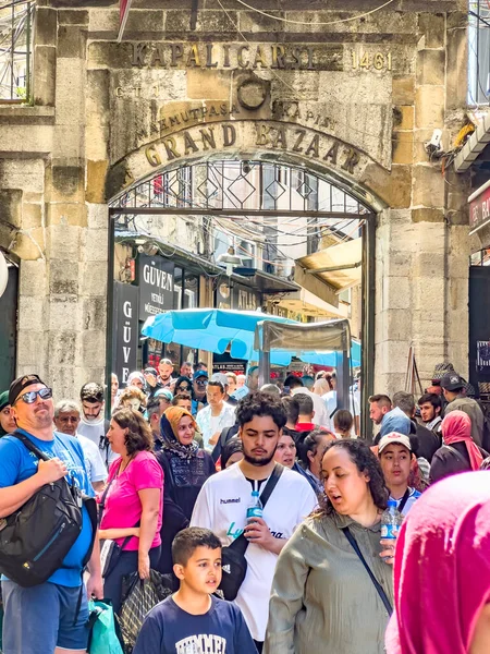 Istanbul, Turkey, 07.14.2022: Grand Bazaar Mahmutpasa Gate Entrance with massive tourist crowds. The largest, oldest covered market in the world. Over 4000 shops, attracting thousand visitors daily
