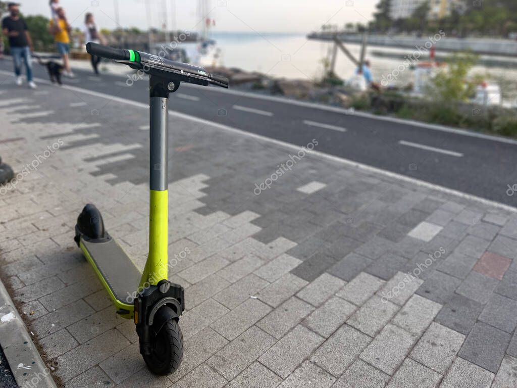 Modern EScooter 'to rent' electric kick scooter parked in the bicycle
