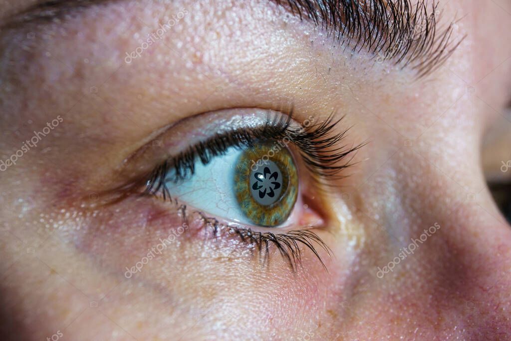 Worldcoin logo on eye ball. Worldcoin is a digital currency that launches by giving away a piece to every person in the world.