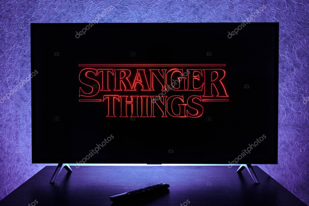 Watching Stranger Things television show on TV. Stranger Things is an American science fiction horror drama television series created by the Duffer Brothers and streaming on Netflix.