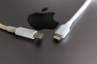 Apple logo arka planında Apple şarj aleti ve USB tip C şarj edici