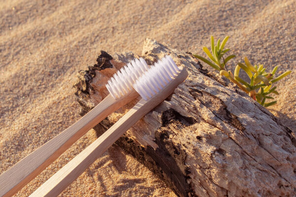 Bamboo toothbrush on the sand. Preservation of nature. Natural product. Environmentally friendly product. Preservation of teeth. Oral hygiene.