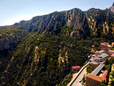 The aerial view of Santa Maria de Montserrat, an abbey of the Order of Saint Benedict located on the mountain of Montserrat in Monistrol de Montserrat, Catalonia, Spain clipart