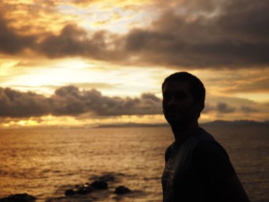 SILHOUETTE OF A MAN WITH SUNSET IN A BEACH IN GUANACASTE