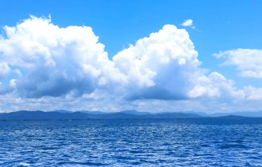 The front view in the morning sky is bright blue with clear white clouds and wide indigo sea during daytime feel calm, refreshing for cool background and copy space above.