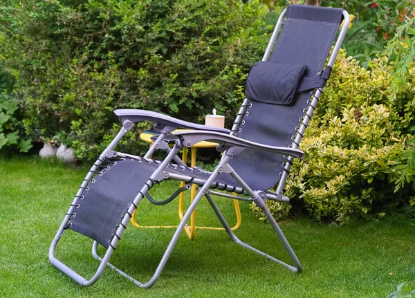 A deckchair on the lawn in the home garden