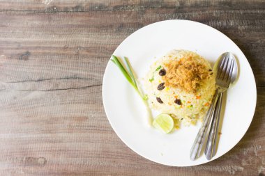 Kızarmış pilav ve beyaz tabakta kurutulmuş domuz eti..