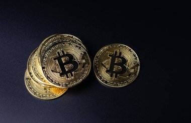Şifreleme para birimi olarak Bitcoin Sikkeleri siyah arkaplan üzerine yerleştirilmiştir