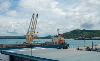 Industrial port crane lift up loading export containers box onboard at port of Thailand.