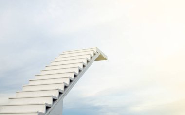 A white staircase stretches up the horizon. That means to be success or go to heaven.