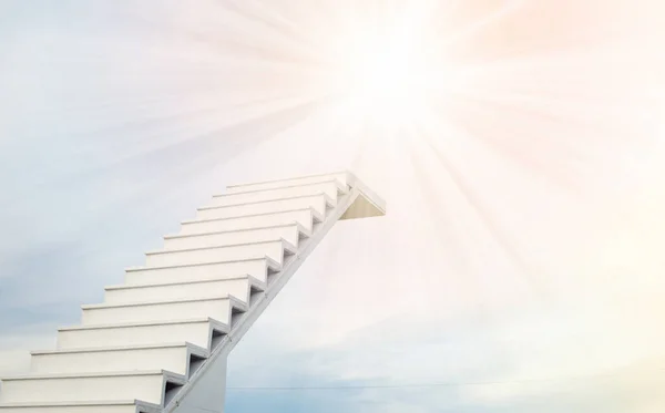 A white staircase stretches up the horizon. That means to be success or go to heaven.