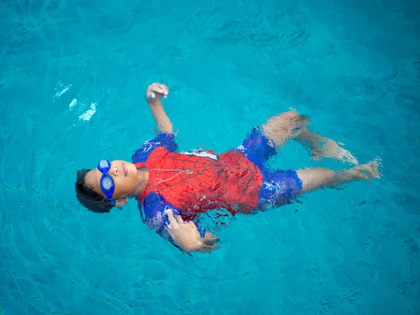 Boy Wearing Swimsuit Glasses Swimming Middle Pool Blue Water Background —  Fotos de Stock