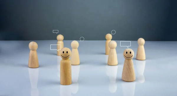 Wooden doll figure with communication and technology symbols. Social media and technology concept.