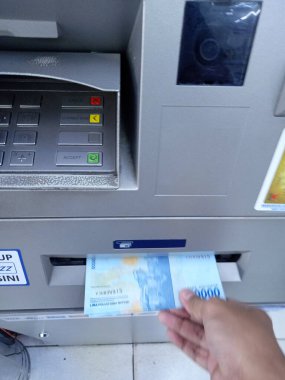 Editör Fotoğrafı, Endonezya, Doğu Jakarta, 02 Ekim 2021, Man Take Money 50000 rupiah ATM BCA