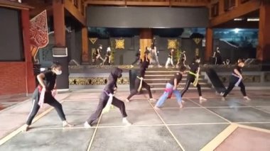 footage no Sound editorial, tmii, taman mini indonesia indah, east java pavilion or anjungan, boy and girl practising glipang traditional dance