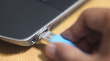 no Sound footage working asian man plug in and out usb cable at notebook 