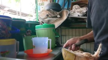 Endonezya, Doğu Jakarta, 12 Ekim 2022, adam hindistan cevizini müşteriye götürmek için hazırlıyor.